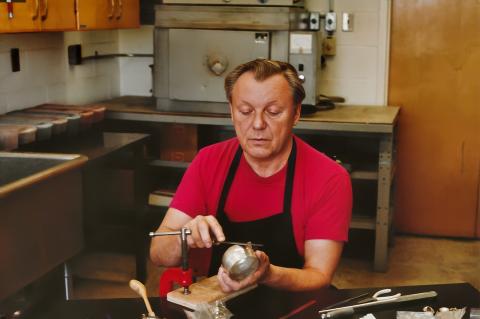 Orland Larson working on a silver goblet in the jewellery studio at the Alberta College of Art. 