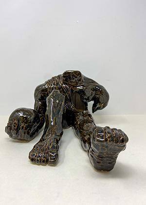 Ceramic sculpture of a headless person.