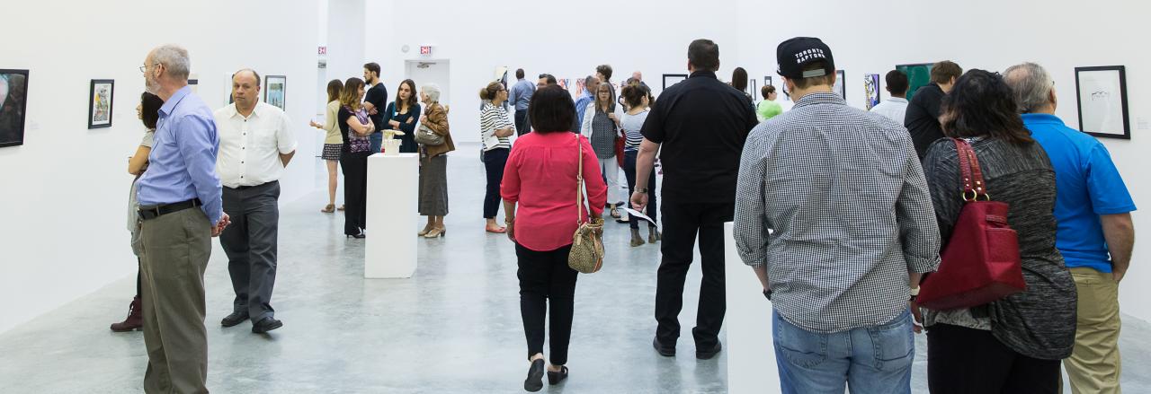 a group of people viewing pre-college closing exhibit