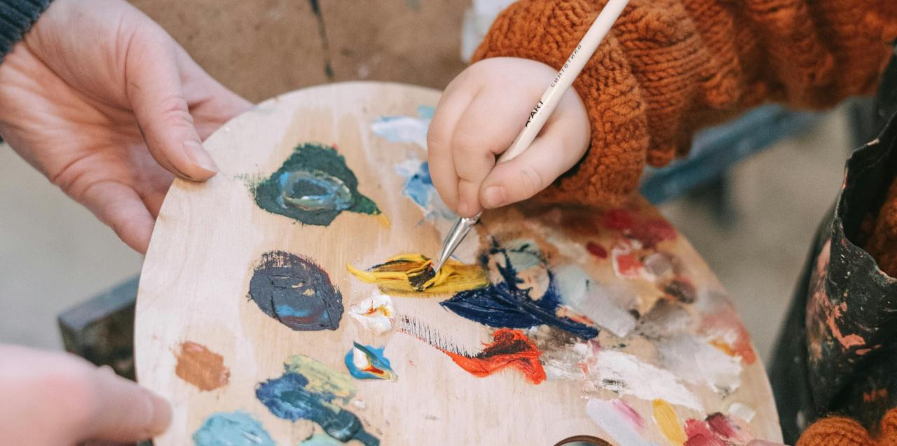 parent and child participating in painting class