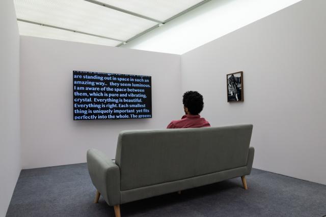 Man watching video from The Beyond Within showing text across the screen