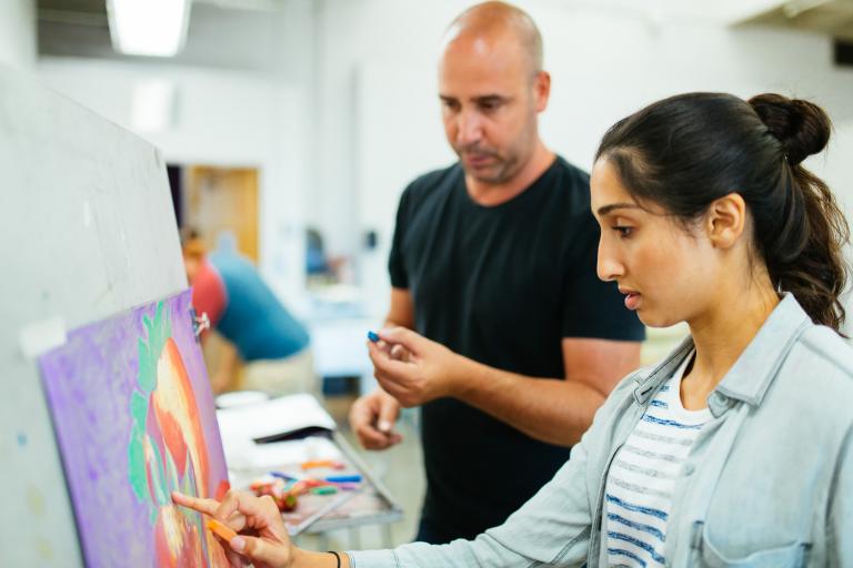 student pants on canvas while instructor guides her