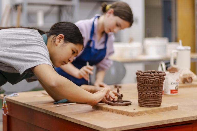 Teen ceramics student working on a hand molded project