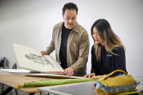 AUArts Portfolio Show Instructor reviewing portfolio for student